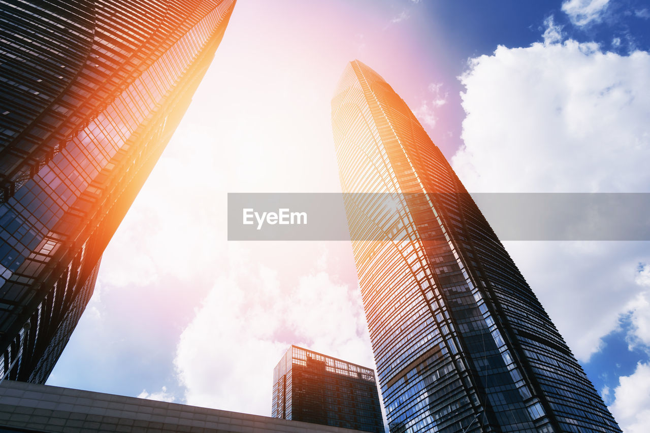 Low angle view of buildings against cloudy sky