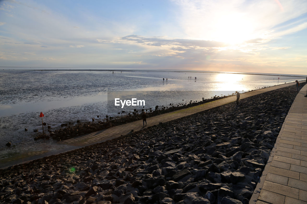 Scenic view of beach against sky during sunset