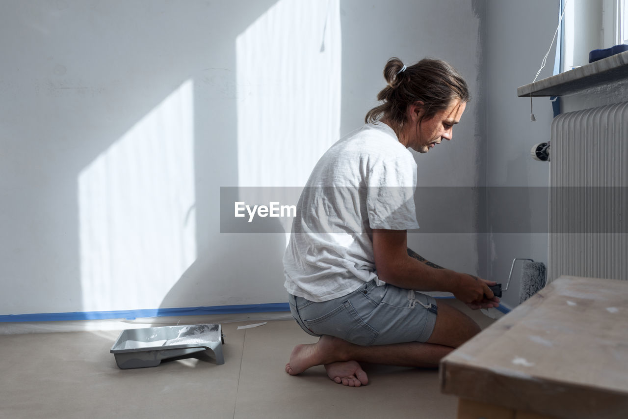 Man painting walls at home