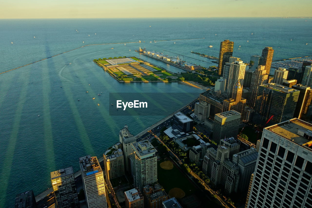 High angle view of buildings by sea against sky