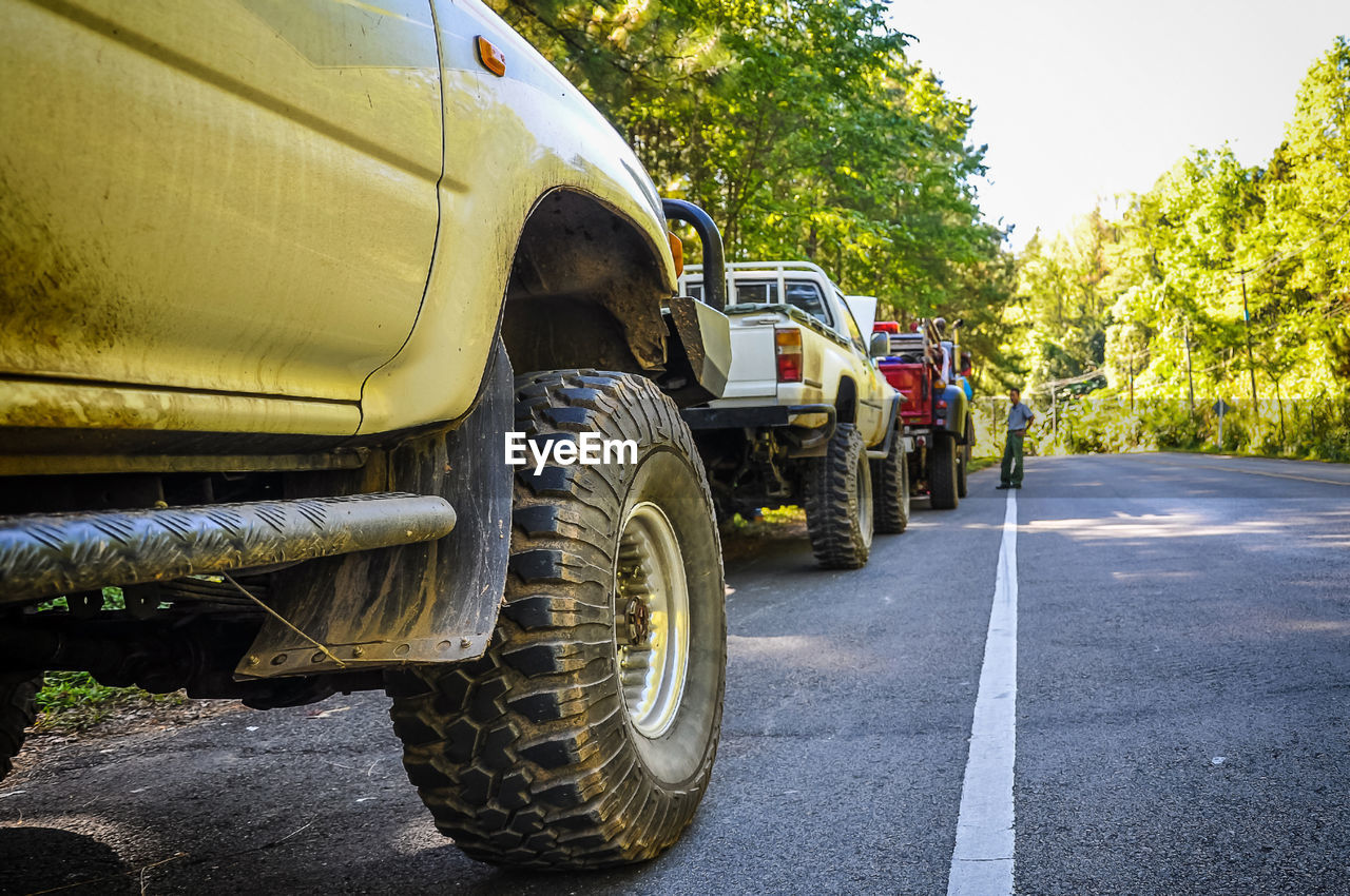 Row of pick-up trucks on road