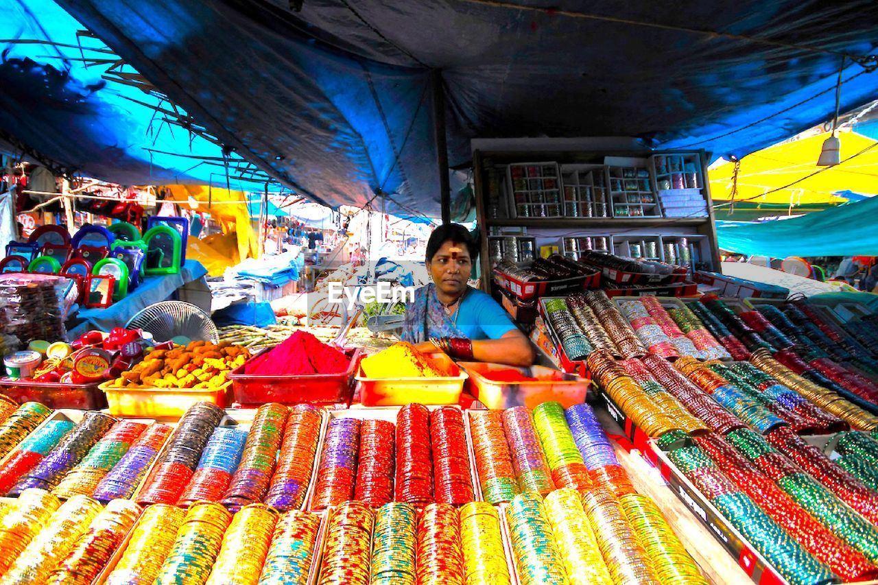 Woman selling bangles at market stall