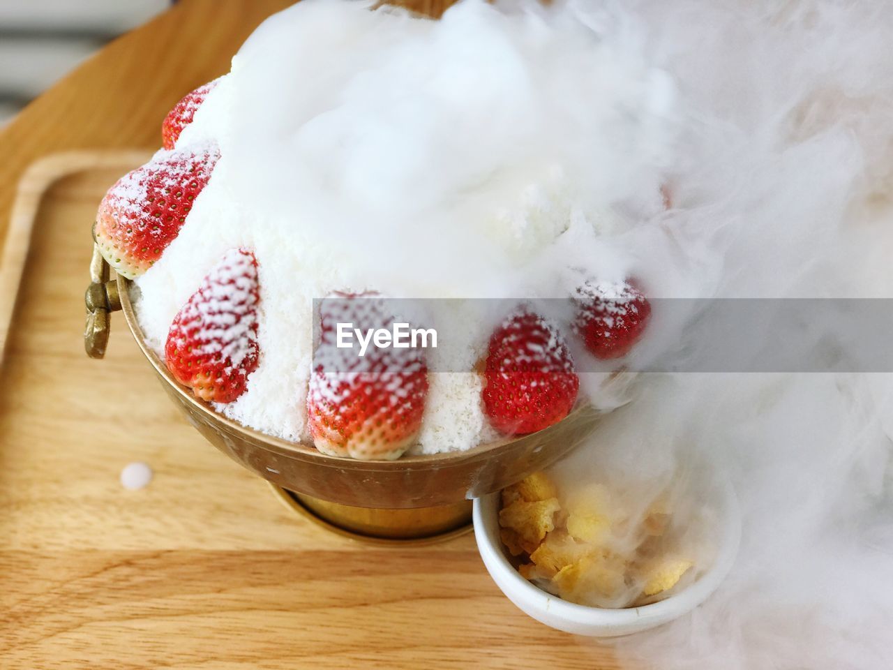 CLOSE-UP OF ICE CREAM ON TABLE