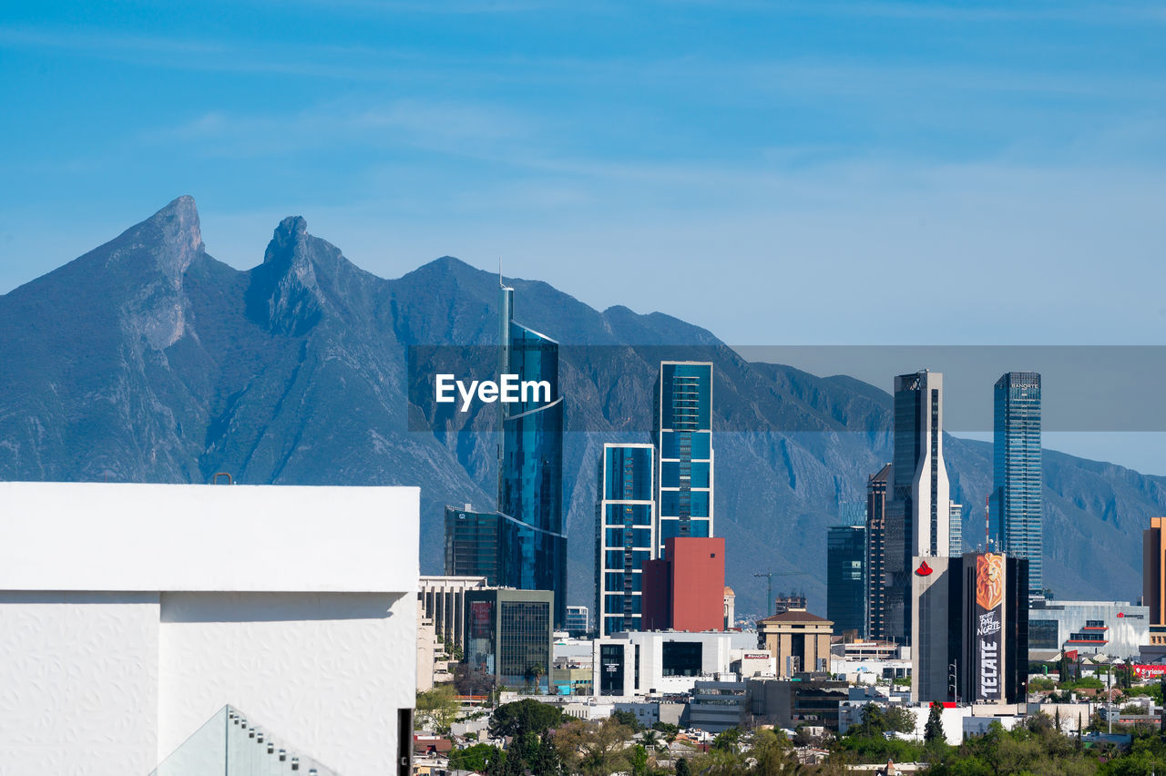 MODERN BUILDINGS AGAINST BLUE SKY