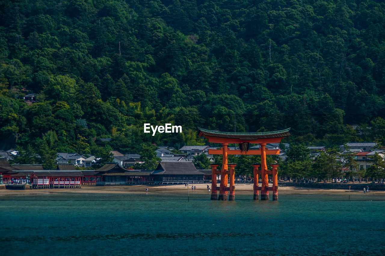 Shrine at beach against sky