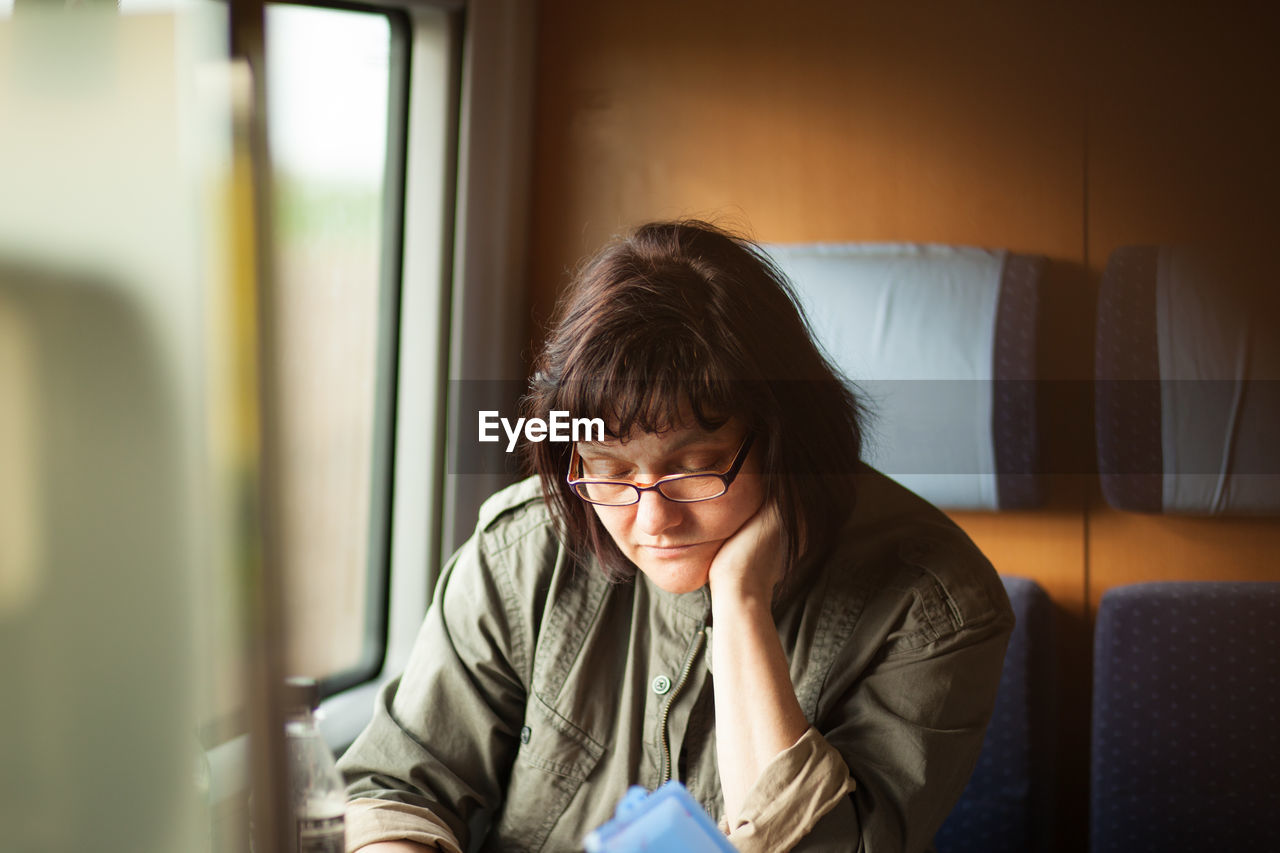 Mature woman sitting in train