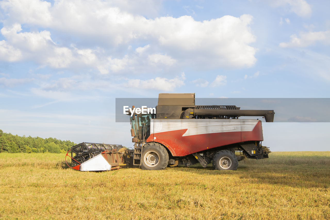 Old combine harvester harvests. agricultural combine on the field