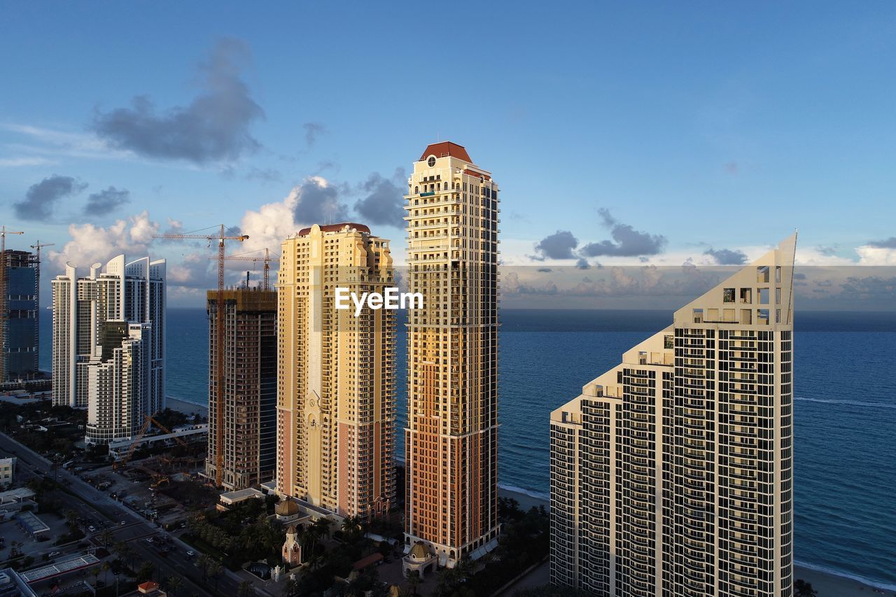 Modern buildings in city against sky