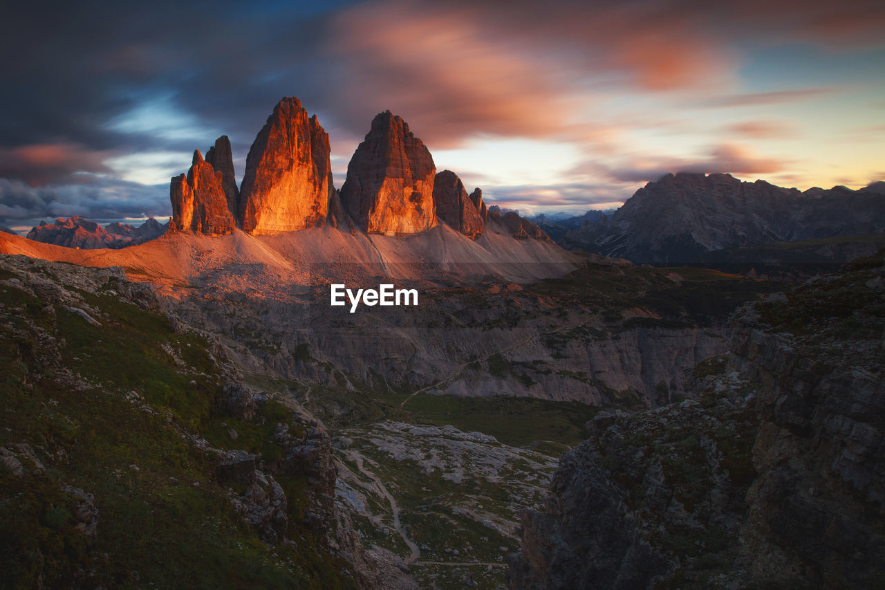 Rock formations on landscape against sky during sunset