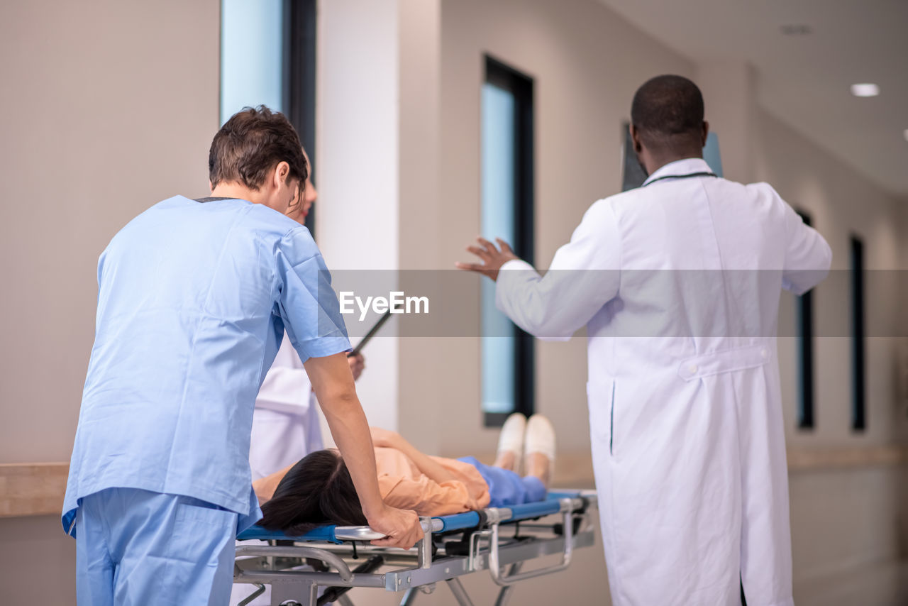 side view of doctor examining patient in office