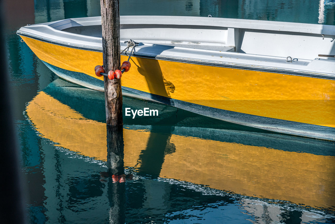 High angle view of yellow boat moored in harbor