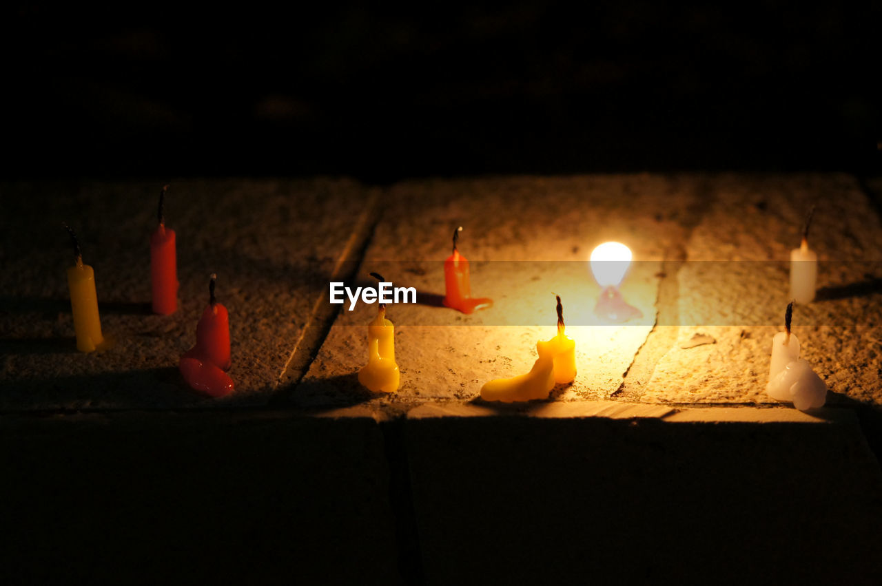 CLOSE-UP OF ILLUMINATED LIGHTS ON FLOOR