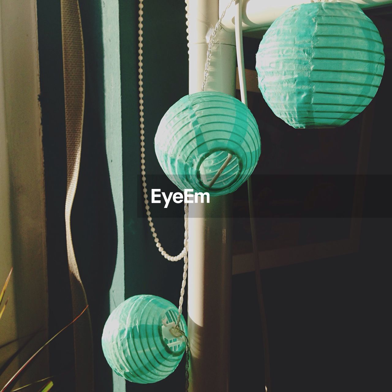 Close-up of paper lanterns hanging on pole