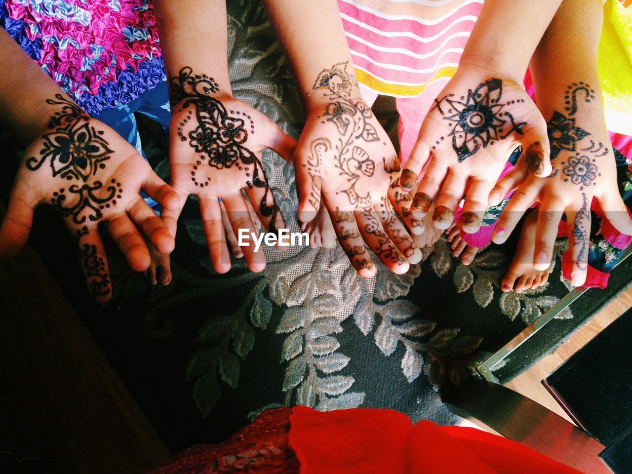High angle view of people with henna tattoo