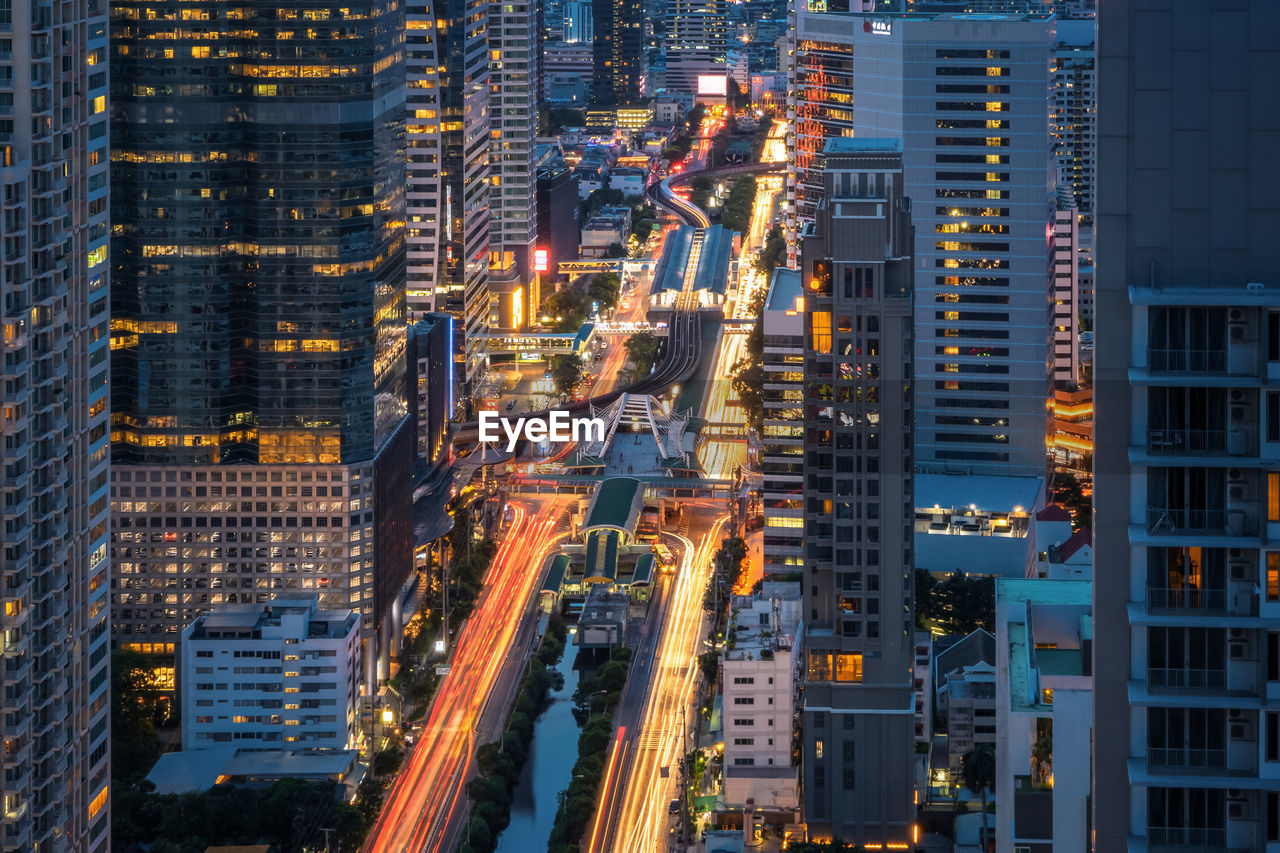 AERIAL VIEW OF ILLUMINATED BUILDINGS AT NIGHT