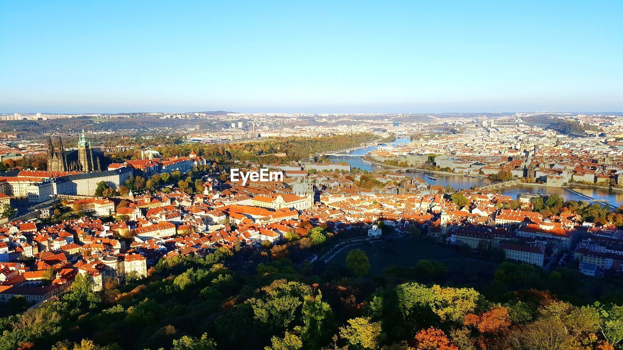 High angle view of houses in town against clear sky