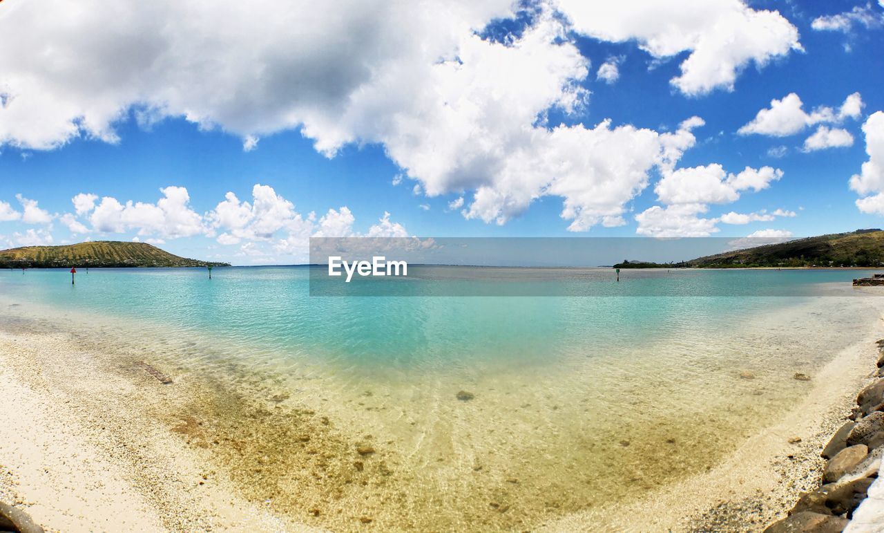 View of beach against cloudy sky