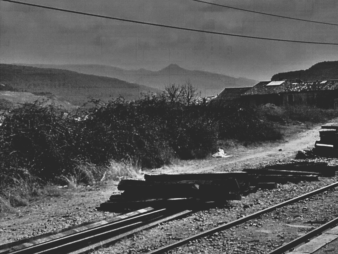 Rural railroad tracks against mountain range