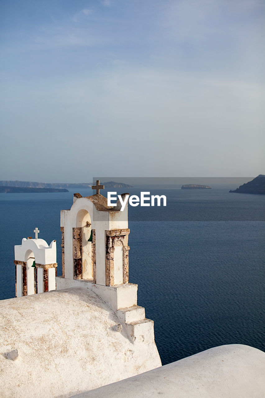 Scenic view of sea against sky with church in foreground