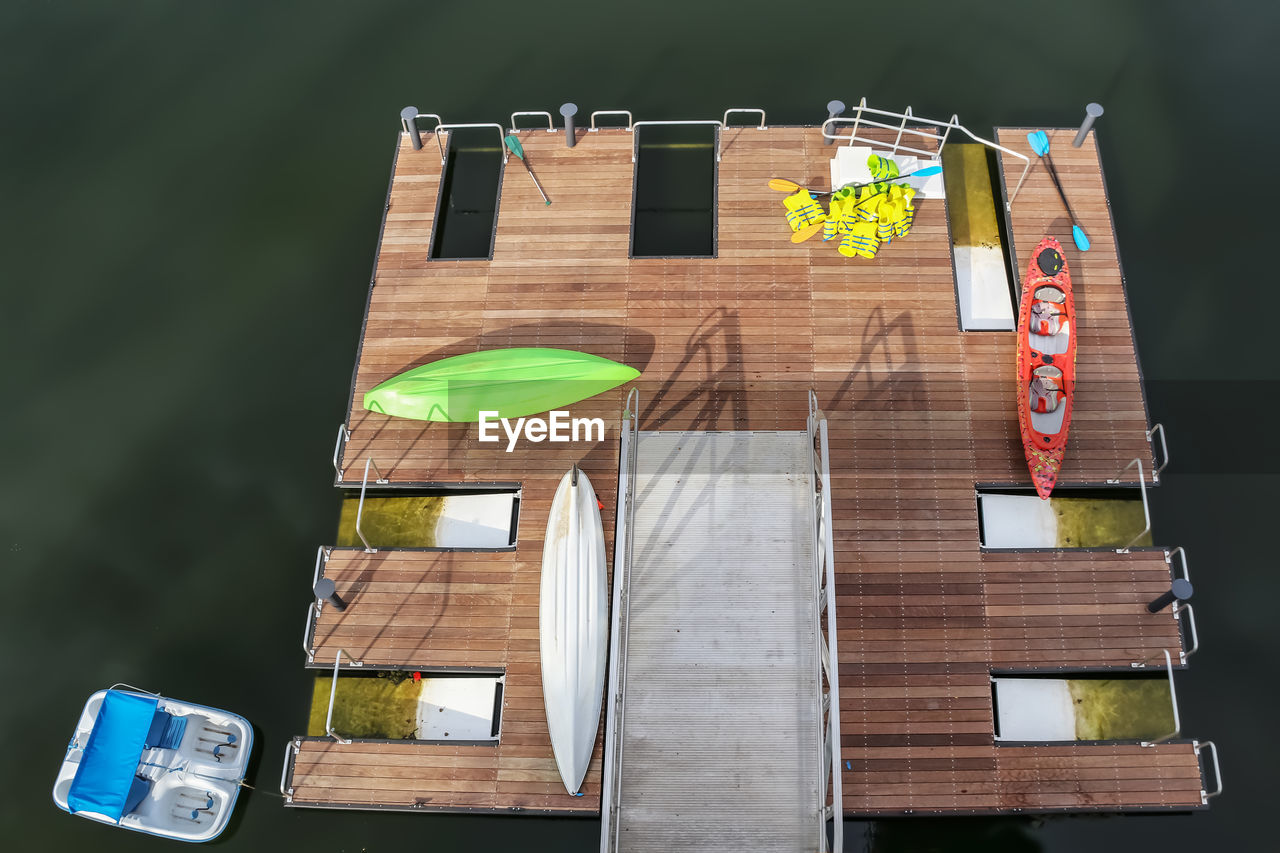 HIGH ANGLE VIEW OF FLAGS HANGING ON WOODEN TABLE