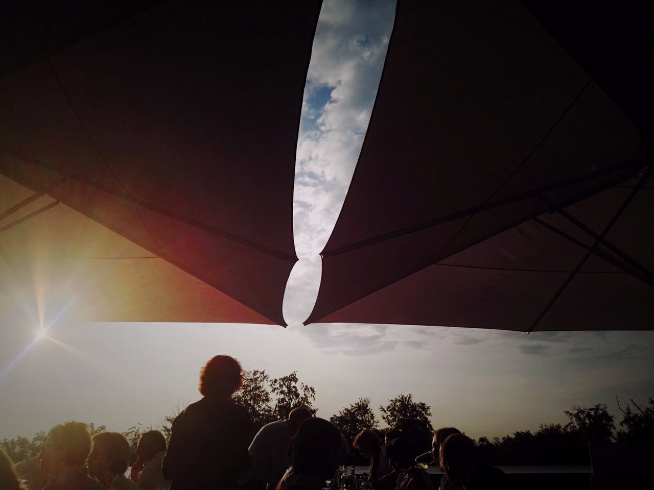 LOW ANGLE VIEW OF WOMAN STANDING AGAINST SKY