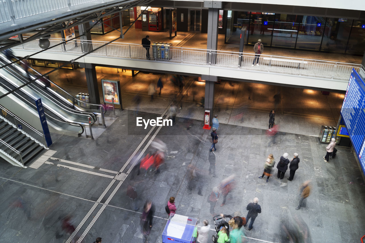 HIGH ANGLE VIEW OF PEOPLE ON ROAD