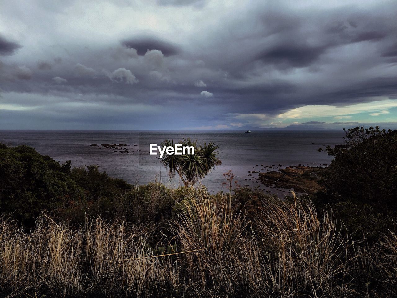 VIEW OF SEA AGAINST CLOUDY SKY