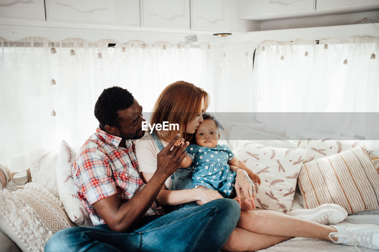 Cheerful family siting in camper van