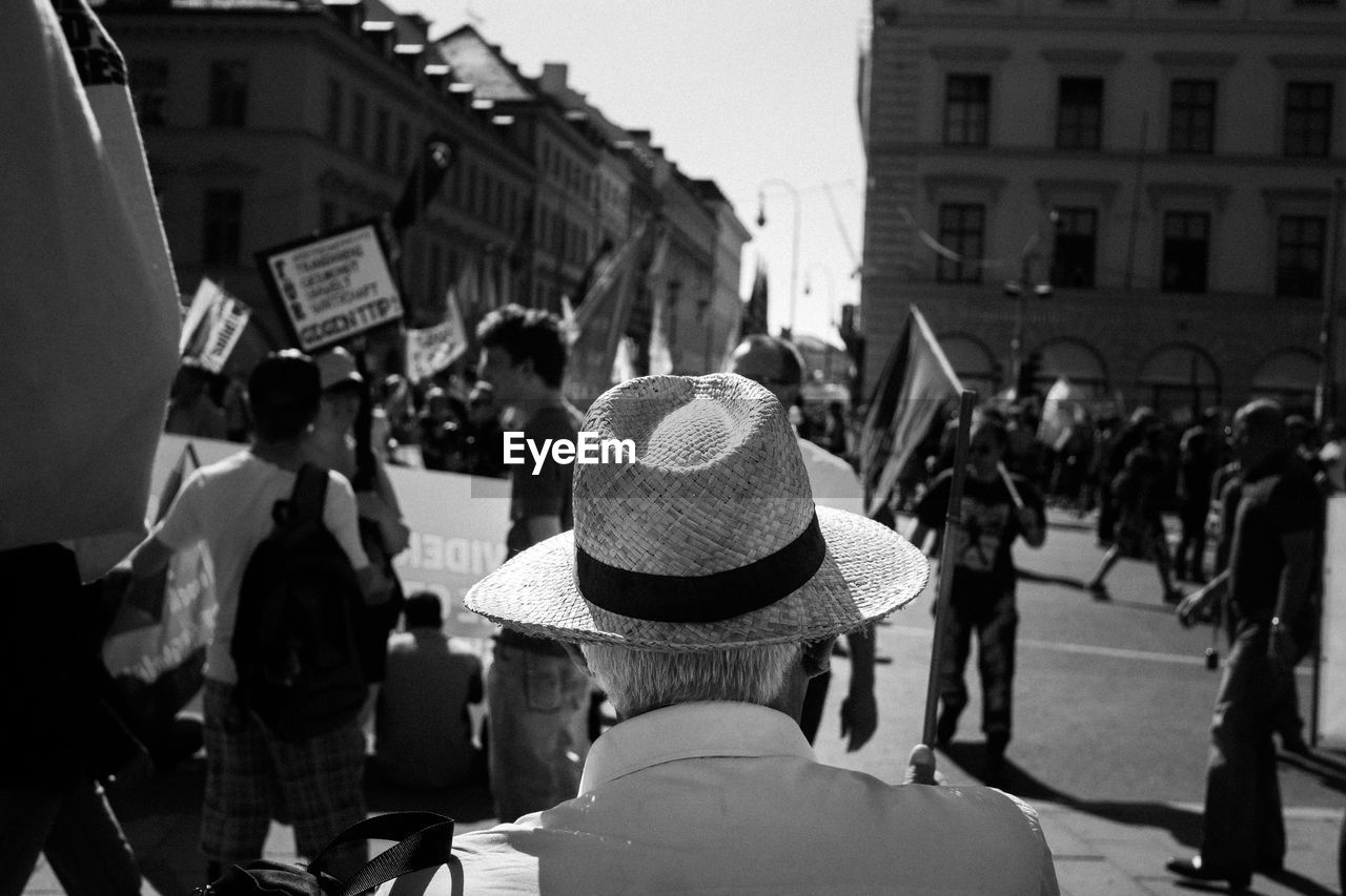 Rear view of man wearing hat in city