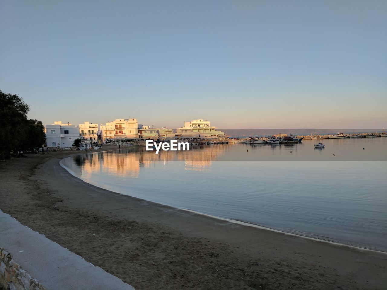 View of city at waterfront during sunset