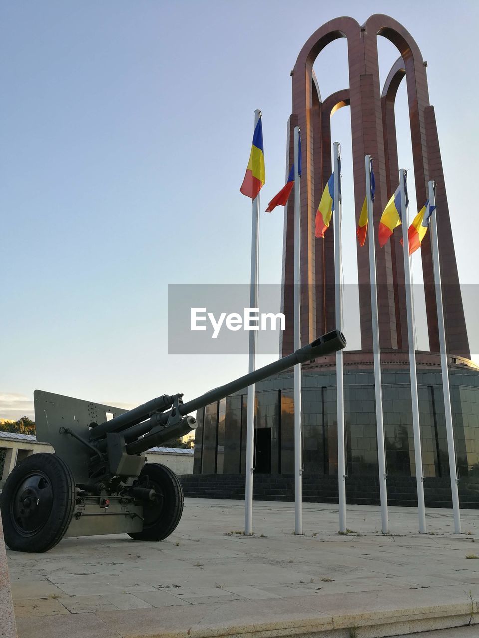 LOW ANGLE VIEW OF FLAG ON BUILT STRUCTURE AGAINST SKY