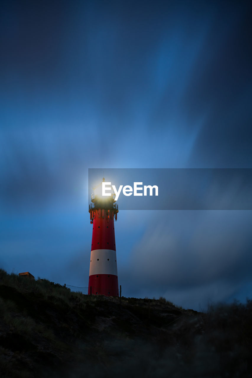 Lighthouse in hörnum on sylt island germany at night with drifting clouds