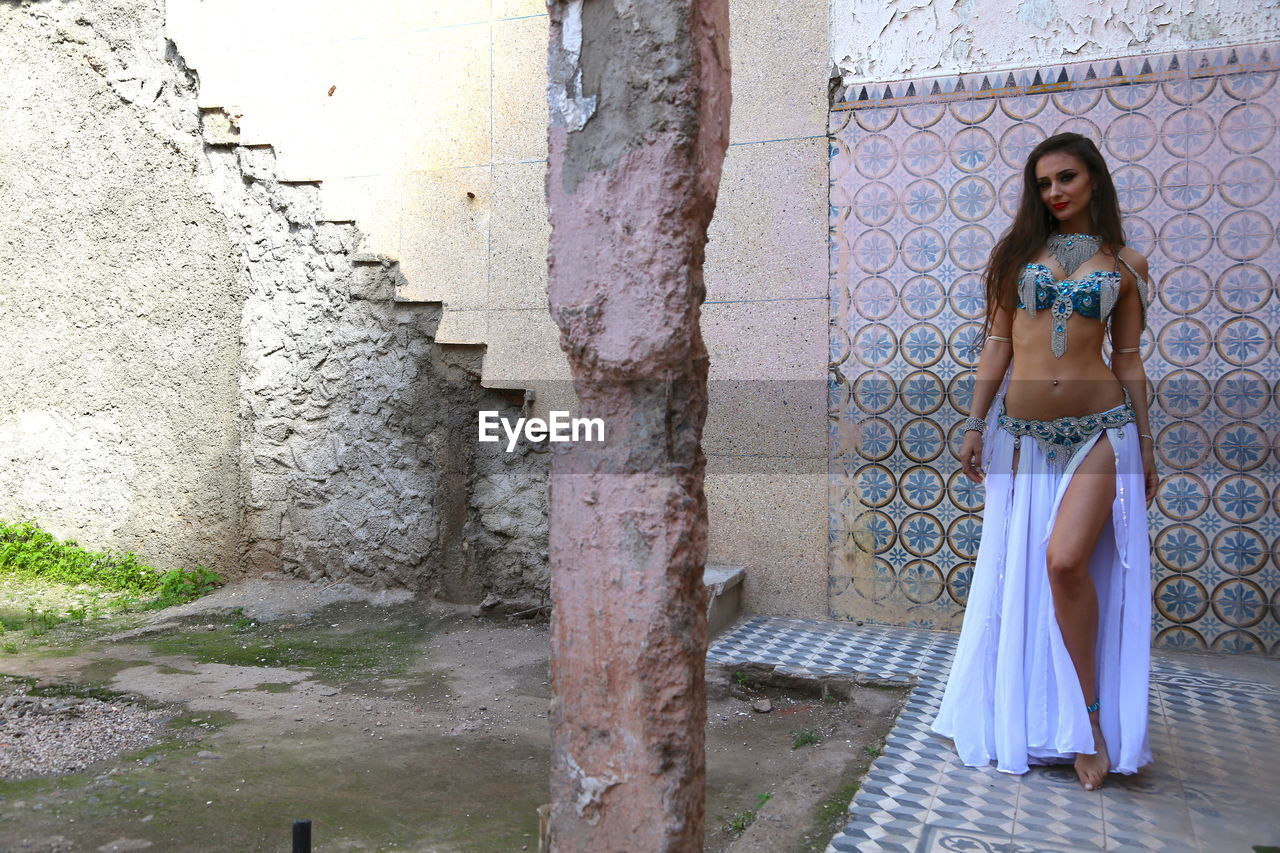 Portrait of beautiful young bellydancer wearing her belly dancing outfit and standing outdoors