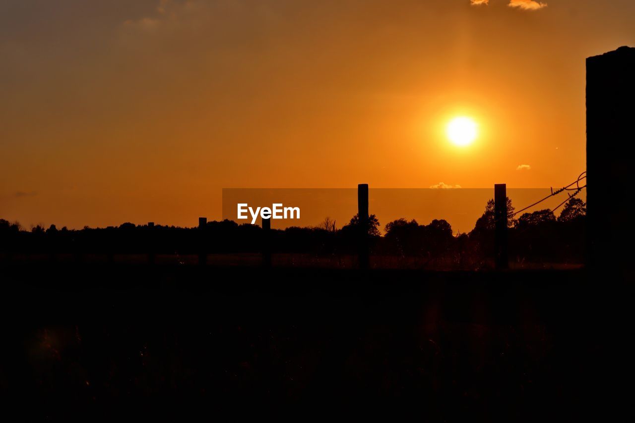 Silhouette landscape against sky during sunset