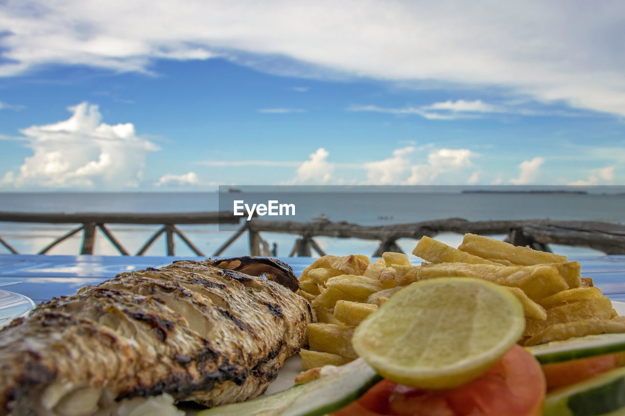 Close-up of food on table against sky