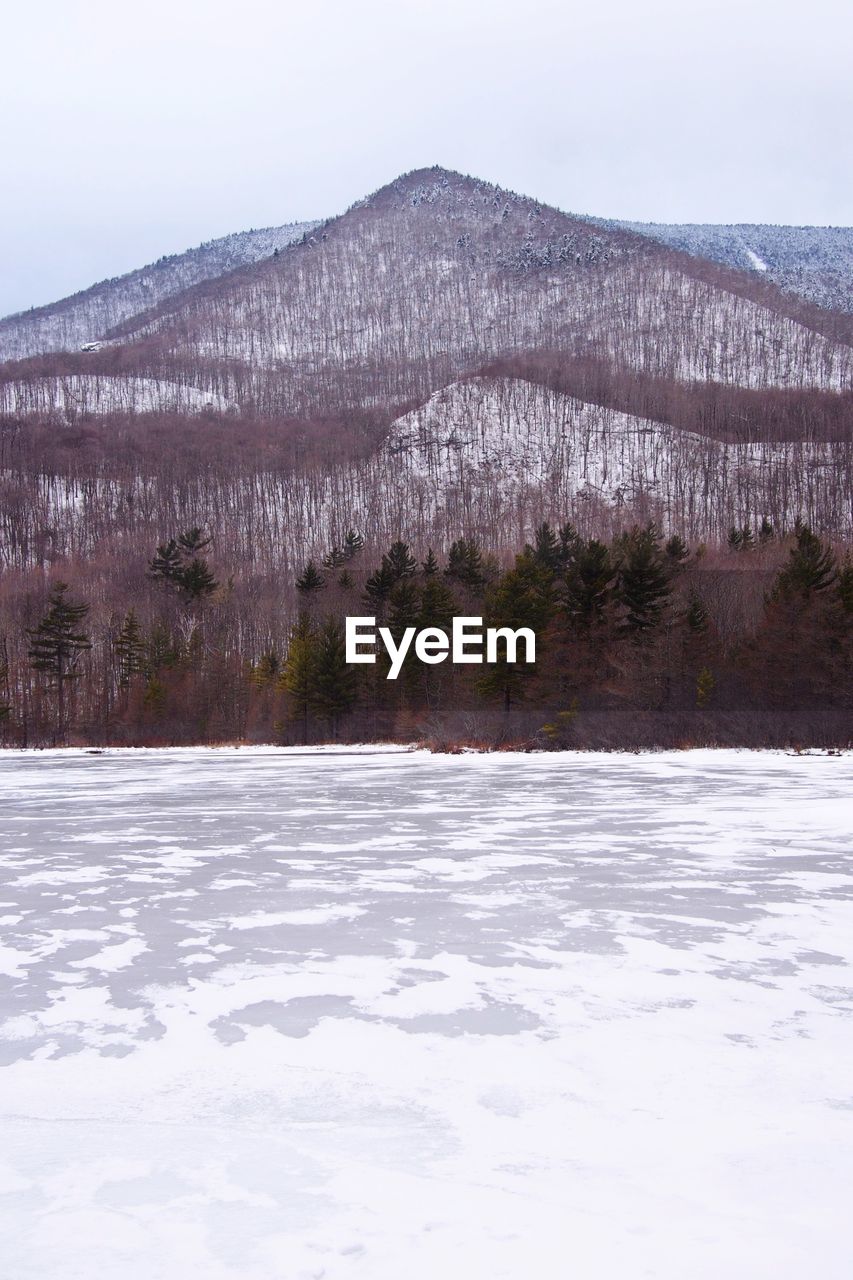 Frozen lake against mountain