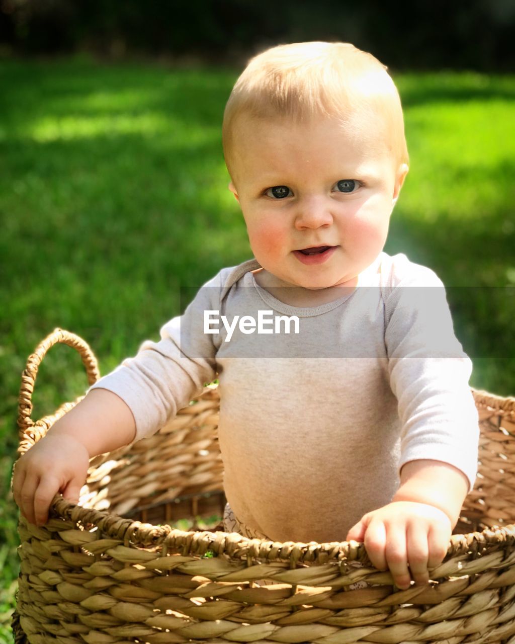 PORTRAIT OF CUTE BABY GIRL WITH BASKET