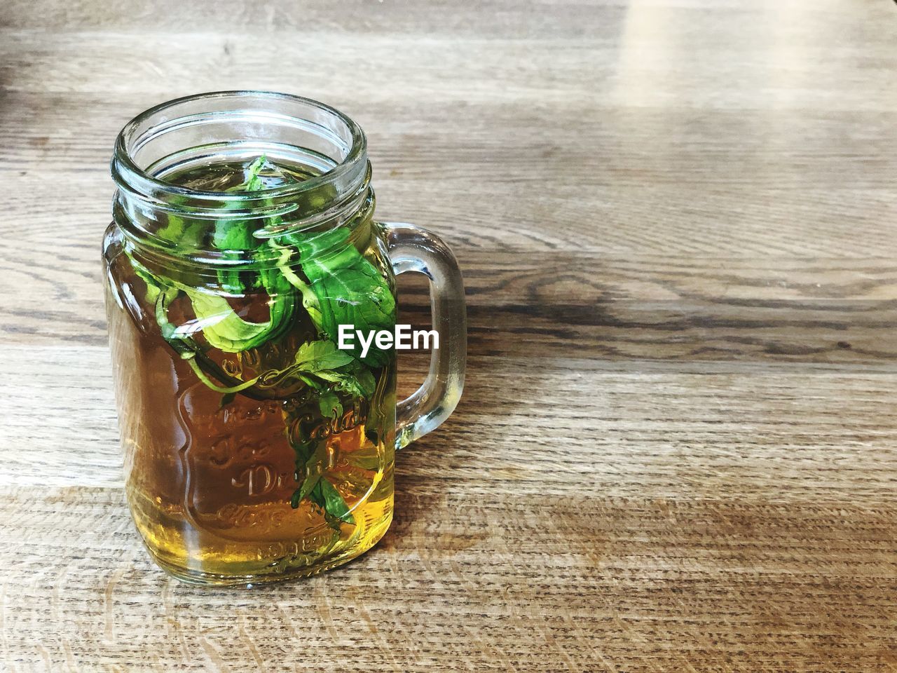 CLOSE-UP OF GLASS JAR ON TABLE