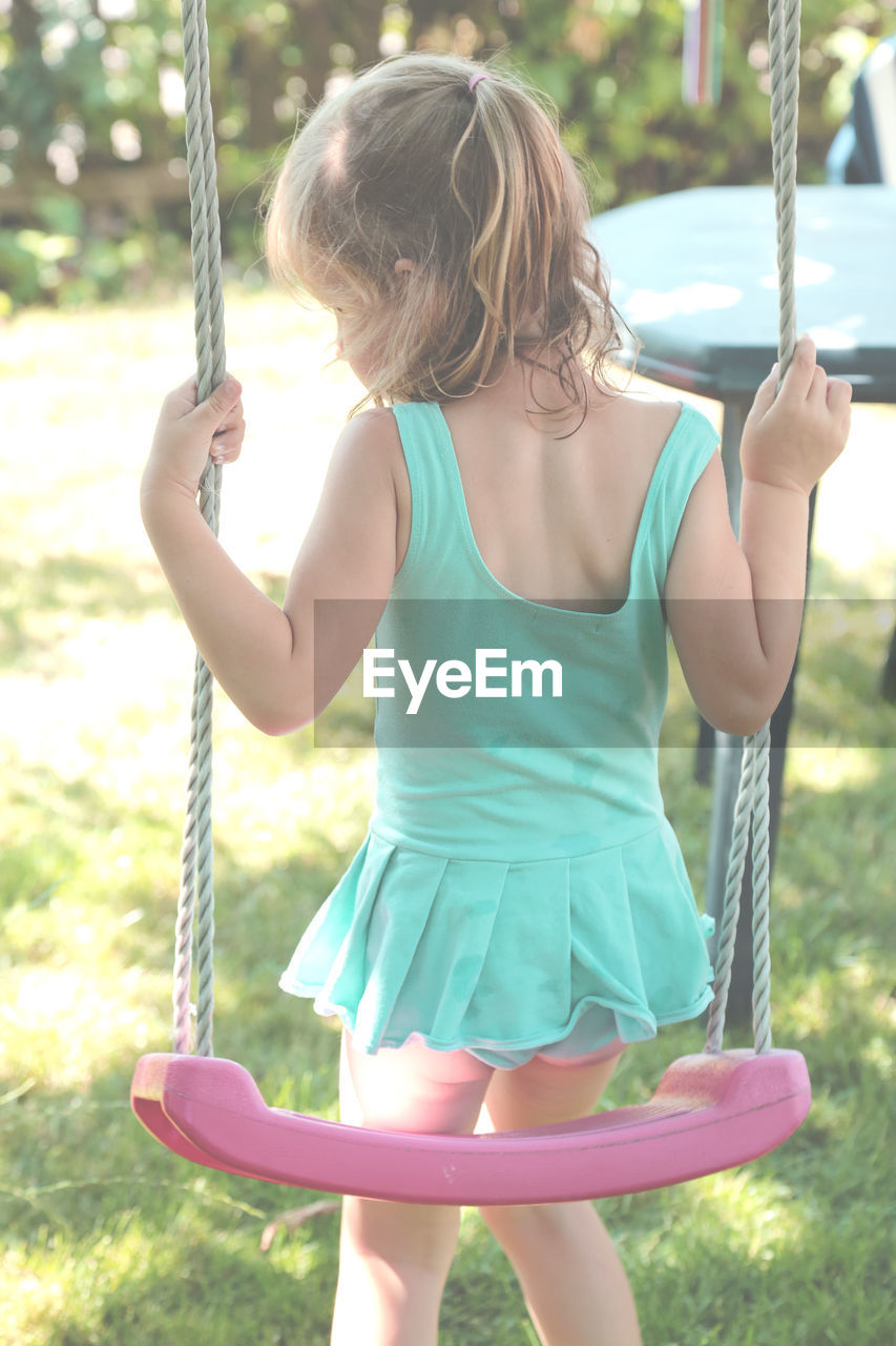 Girl playing on swing