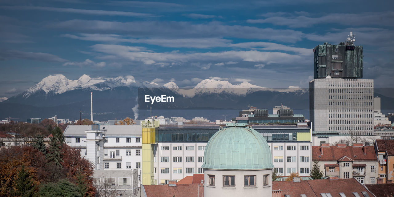 High angle view of buildings against mountain and sky