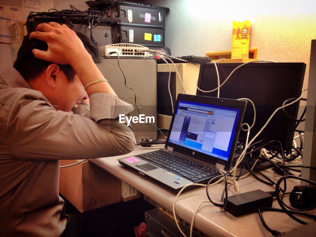 Profile shot of angry businessman with laptop in office