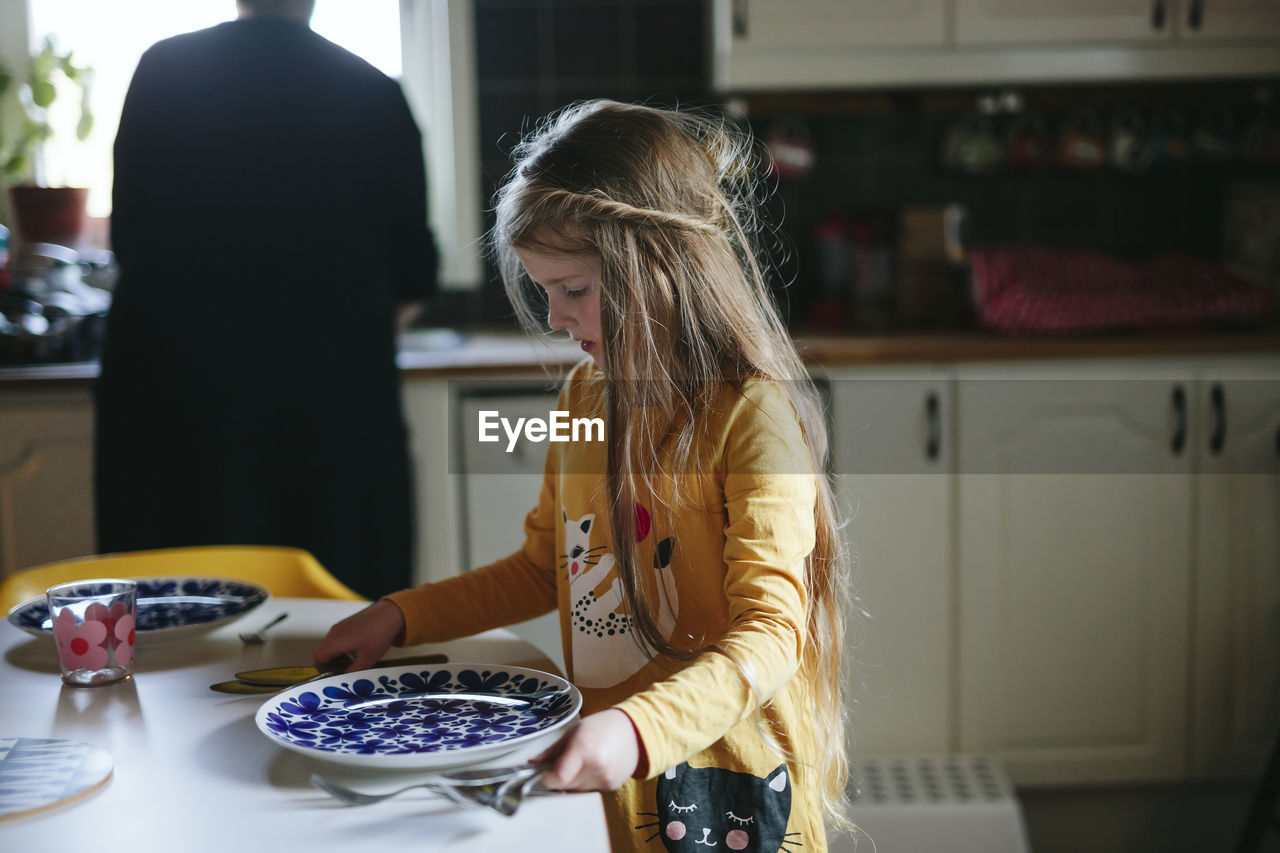 Girl setting table