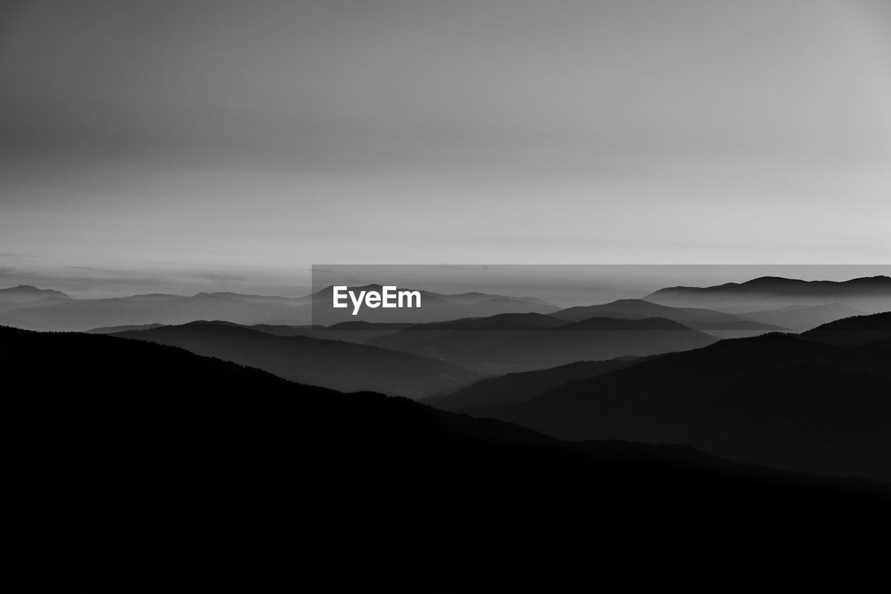 Scenic view of silhouette mountains against sky