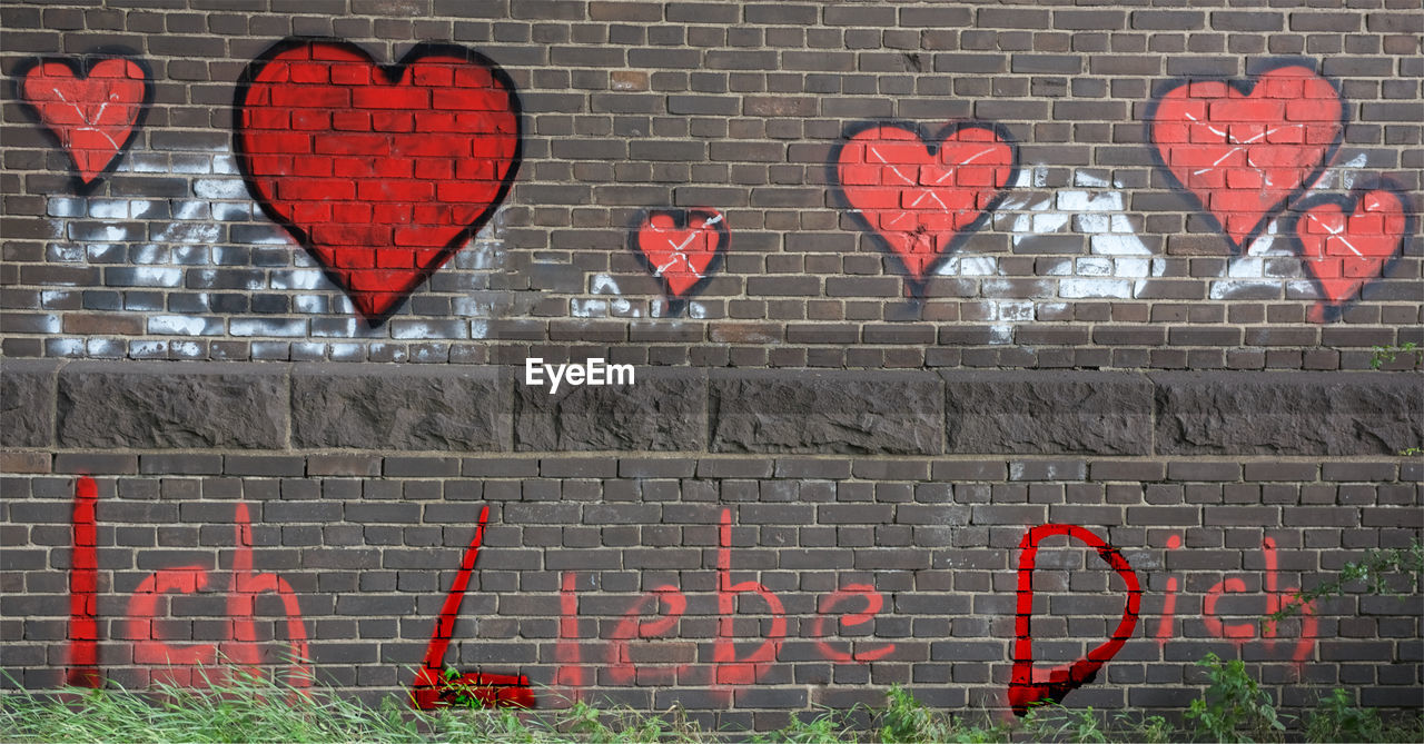 Close-up of brick wall / love