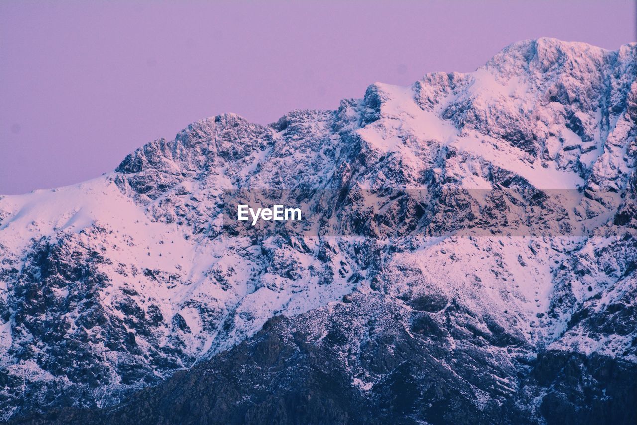 SNOW COVERED MOUNTAINS AGAINST SKY