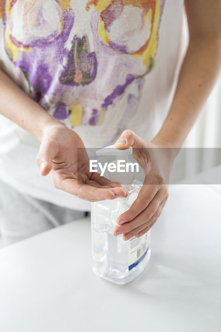 Person applying hand sanitizer