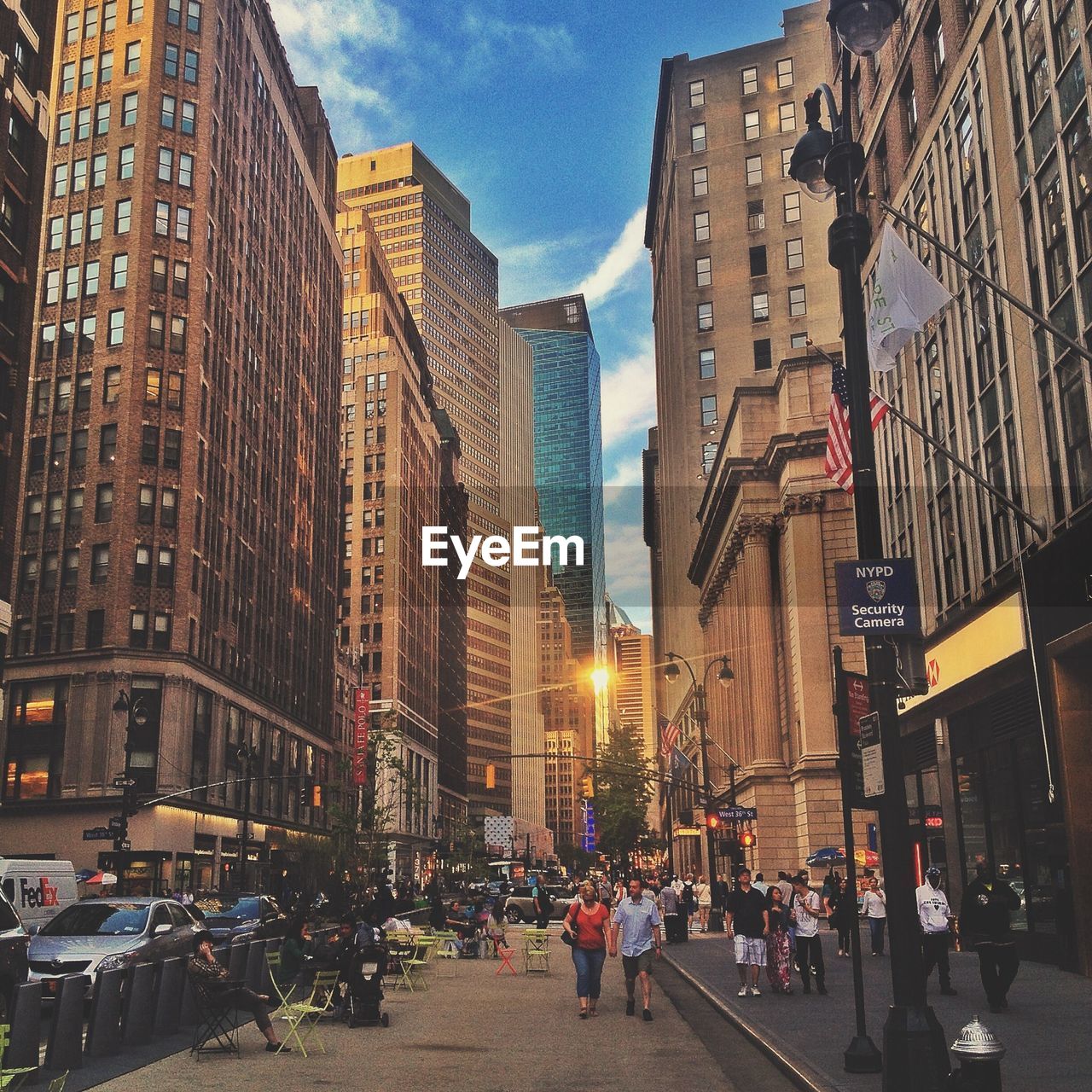 People walking on road along buildings