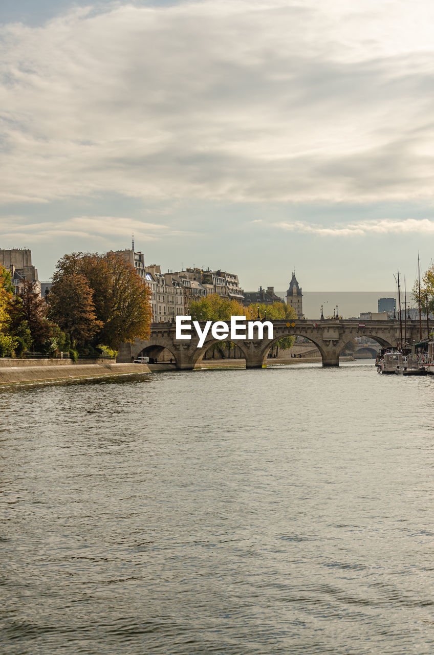 Bridge over river against buildings in city