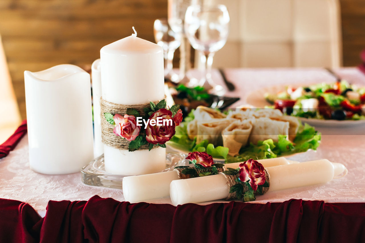 Arrangement of candles and dishes on a wedding table