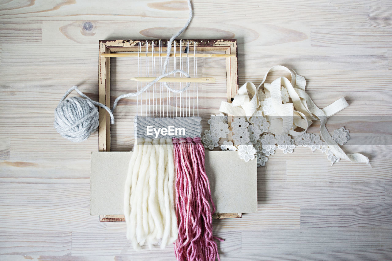 Directly above shot of knitting equipment on table